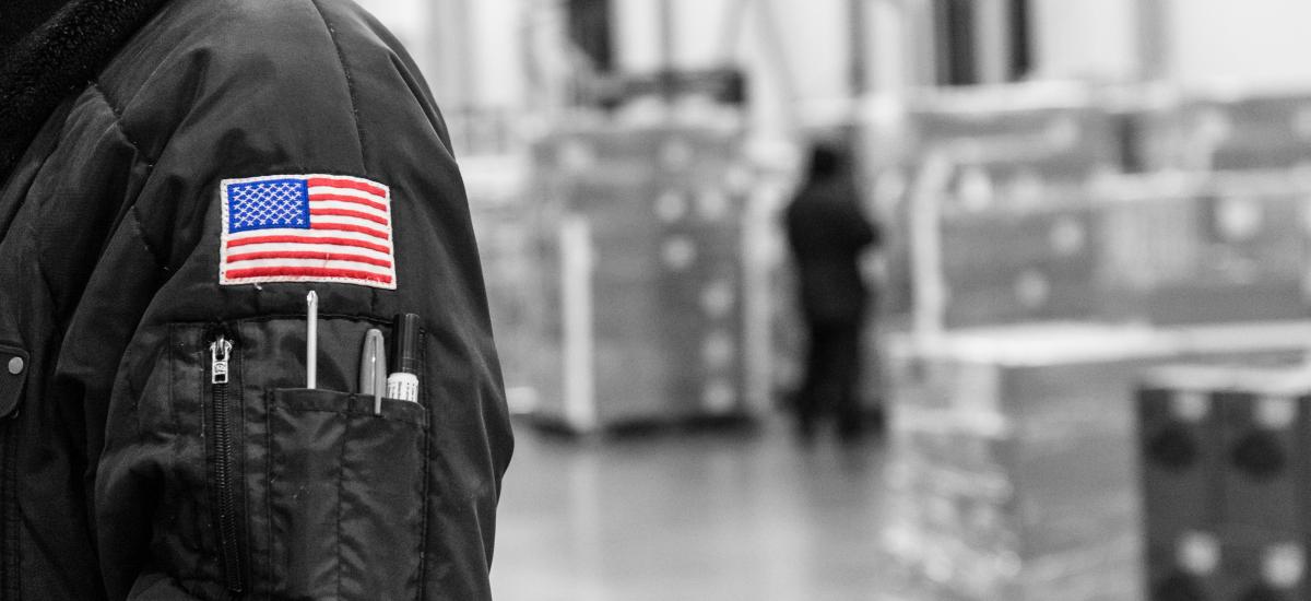 Black and white photo with team member's American flag patch in full color.