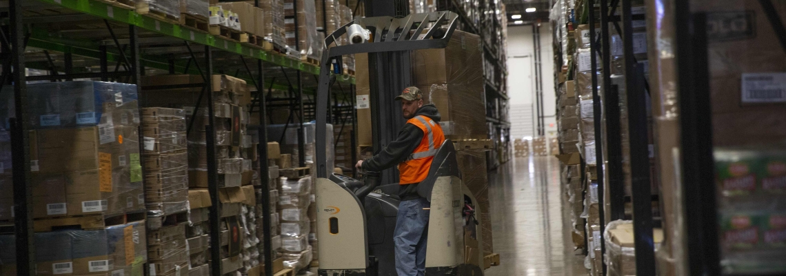 A Lineage team member works in a temperature-controlled warehouse.