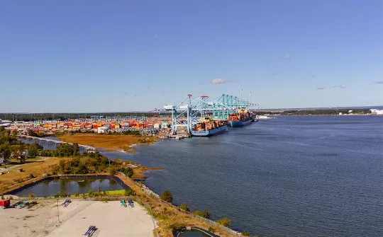 Long-distance photo of shoreline and loaded shipping containers